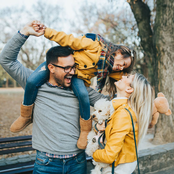 A couple playing with their daughter after her root canal therapy at OKC Dentistry in Oklahoma City