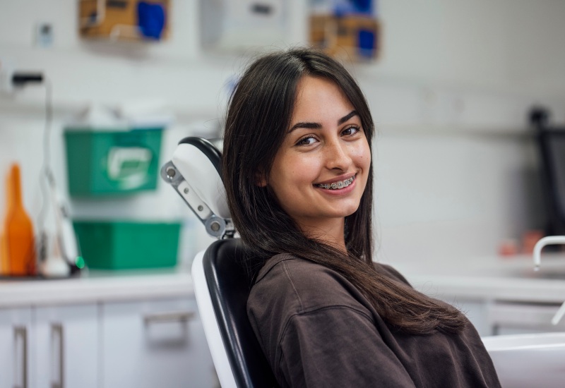 A happy patient smiling after her successful surgery at OKC Dentistry in Oklahoma