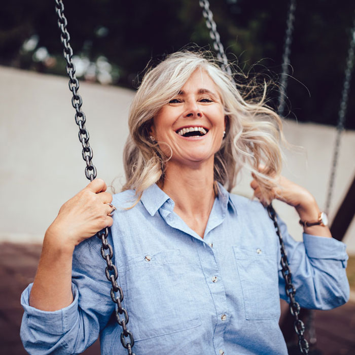 An elderly woman swinging on a swing after her Dental Treatment in Oklahoma City