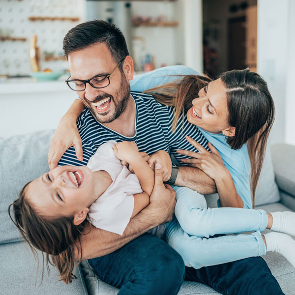 Happy parents playing with their daughter after her Dental Treatment at OKC Dentistry