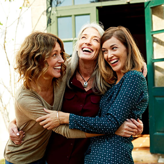 Three women hugging each other after their dental procedure at OKC Dentistry in Oklahoma City