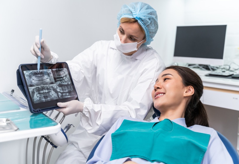 Dentist explain oral care from teeth x-ray to patient in Oklahoma City.